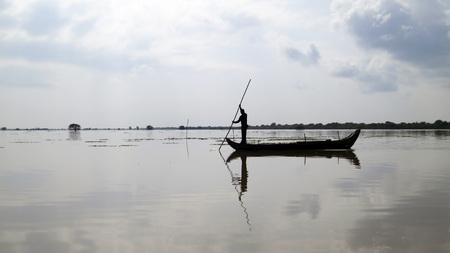 Lone fisherman on the boat, Tonle Sap, Cambodiaの写真素材