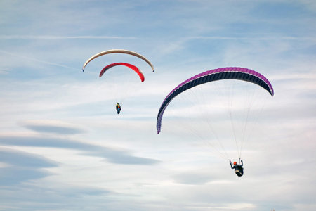 paraglider flying high in the skyの写真素材