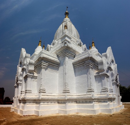 White Pagoda with golden pinnacles in Bagan, Myanmarの写真素材