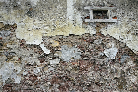 Close up view of crumbling plaster brick wallの写真素材