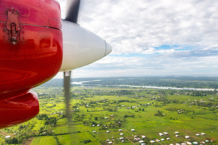 Air travel in Fiji, Melanesia, Oceania. View of Rewa river, Nausori town, Viti Levu island from a window of a small turboprop propeller airplane bound for Vanua Levu, Tuvalu or Levuka, Ovalau island.の写真素材