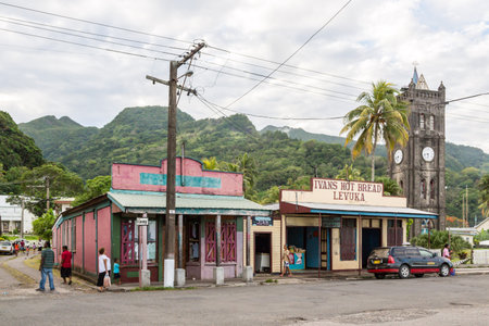 Levuka, Fiji - Jan 9 2015: Colourful vibrant streets of old colonial capital of Fiji: Levuka town, Ovalau island, Lomaiviti archipelago, Melanesia, Oceania, South Pacific Ocean. Church clock tower.のeditorial素材