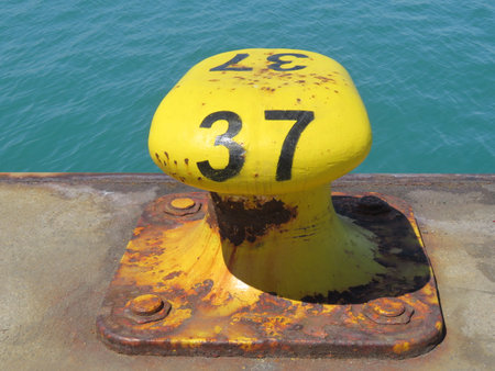 boat mooring, yellow iron bollard, dock number, basinの写真素材