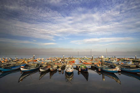 typical boats anchored in the docks with beautiful skyの写真素材