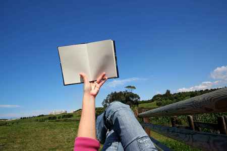 woman reading book in park