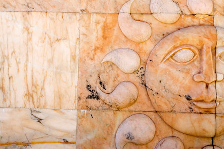 Sun sculpture in marbble wallの写真素材