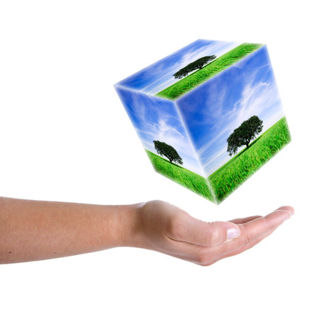 woman hand holding landscape cube in 3d - earth nature and environment conceptの写真素材