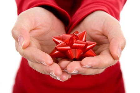 young woman gently holding red ribbon with both hands isolated on white backgroundの写真素材