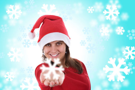 santa woman holding small snowflake in the hand over blue background