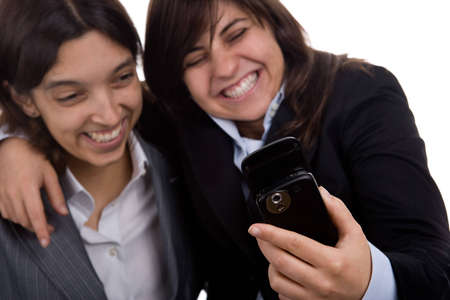 businesswoman with partner laughing with mobile phone isolated on whiteの写真素材