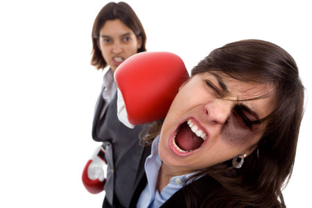 Two businesswoman with boxing gloves fighting. isolated on white background.の写真素材