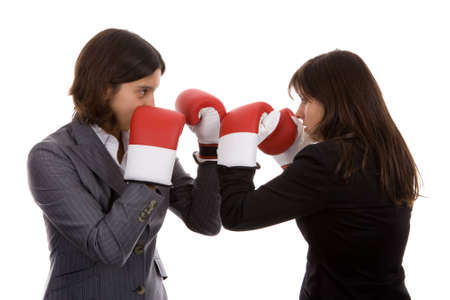 two businesswomen with boxing gloves fighting. isolated on white background.の写真素材
