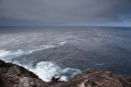 azores shore seascape with dark clouds and rocks - landscape orientationの写真素材