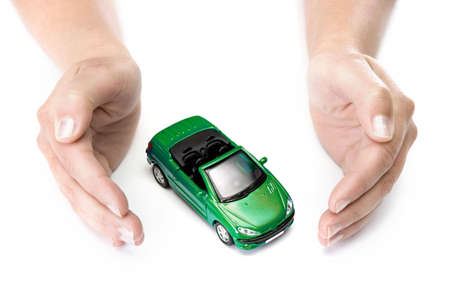 woman hands holding green car isolated on white backgroundの写真素材