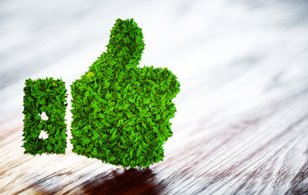 Green thumbs up sign on blurred wooden background. 3D illustration.の写真素材