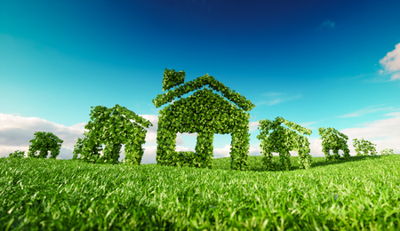 Sustainable eco village concept.  3d rendering of house symbols on fresh spring meadow with blue sky in backgroundの写真素材