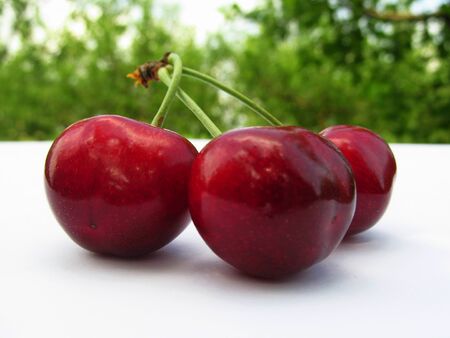 fresh red cherries on a wooden tableの写真素材