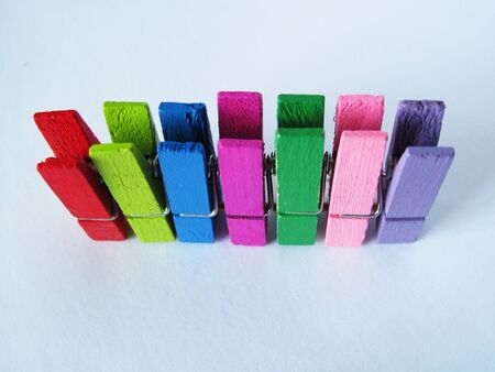 colorful decorative wooden earrings for fastening, for business, training and office on a white backgroundの写真素材