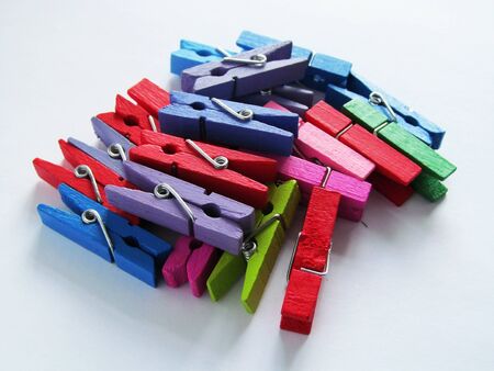 colorful decorative wooden earrings for fastening, for business, training and office on a white backgroundの写真素材