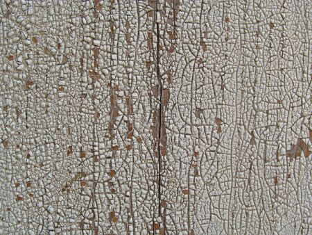 Old and peeled creaky paint , In course of time the paint of white tone peeled off the old planks and crackled, wood texture, background, colorful, cracks in the paint, vintage, abstract, grunge,の写真素材