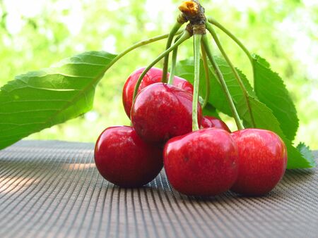 fresh red cherries on a wooden tableの写真素材