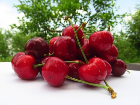 fresh red cherries on a wooden tableの写真素材