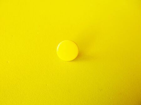 yellow ball on a yellow backgroundの写真素材