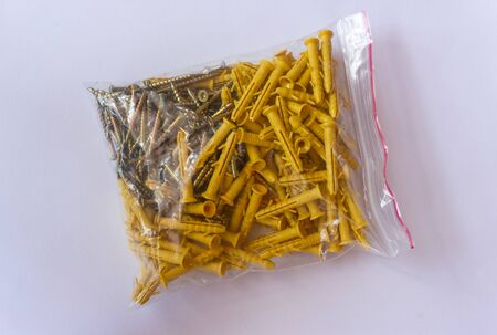 Screws with wall plugs. Dowel. Wall anchors. Pack with screws and dowels for wall repair.の写真素材