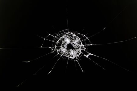 The texture of broken cracked glass after being hit by a solid object. Cracks isolated on white. Concept element for design.の写真素材