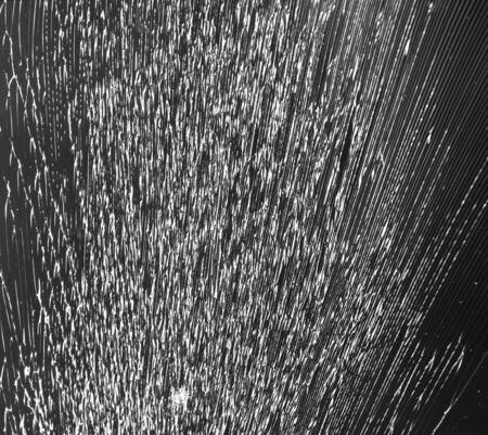 Abstraction of broken glass. Cracked glass on a black background.の写真素材