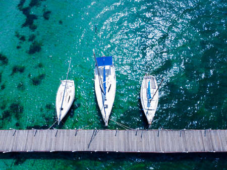 Boats at the pier in the Mediterranean Sea. Turquoise clear water. Recreation and tourism between Europe and Asia.の写真素材