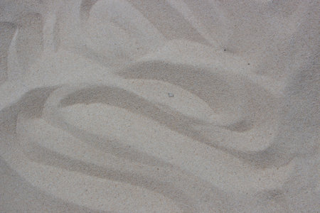 closeup of sand pattern of a beach in the summer