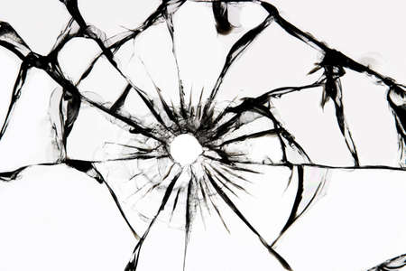 Damaged glass with cracks, cracks in the glass from the shot. Broken window, texture on a white background.の写真素材