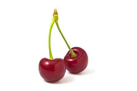 Two cherries isolated on white background. Fresh fruits full focusの写真素材