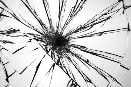 Cracks pattern on broken glass, abstraction of chips and lines from impact on glass.の写真素材