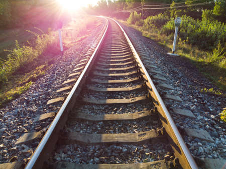 Railroad tracks sparkle in the bright morning sunriseの写真素材