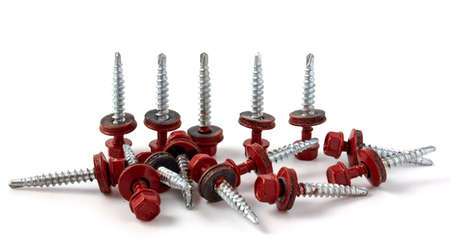 Metal Roofing Screws. Self-tapping screws on metal isolated on white background.の写真素材