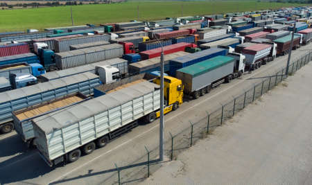 Lots of trucks with trailers in the parking lot. Queue for unloading at the port.の写真素材