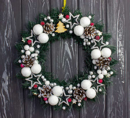 Christmas wreath on a gray wooden background. Christmas decoration on the doorの写真素材