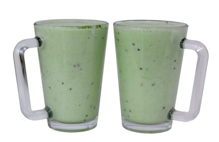 Kiwi and milk smoothie in a transparent cup on a white backgroundの写真素材