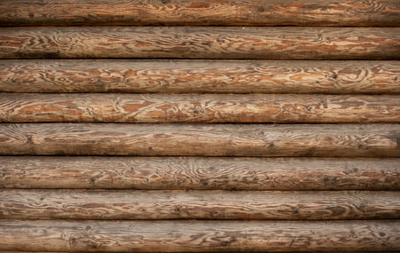 Background of a wooden wall of a house made of a round beam