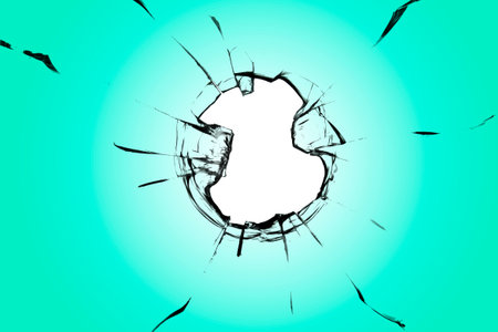 Green broken glass with a hole and cracksの写真素材