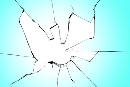 A hole in the glass on a blue background. Broken window with cracked texture, effect for designの写真素材