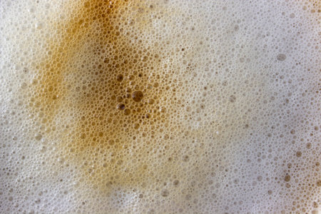 Top view of coffee foam texture. Cappuccino background with whipped foam and small bubbles.の写真素材