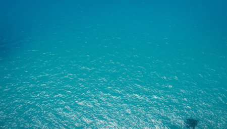 With every wave, the water offers a glimpse into the hidden depths belowの素材