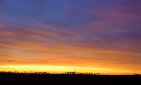 Nature's artistry is on full display as the sky transitions from darkness to brillianceの素材