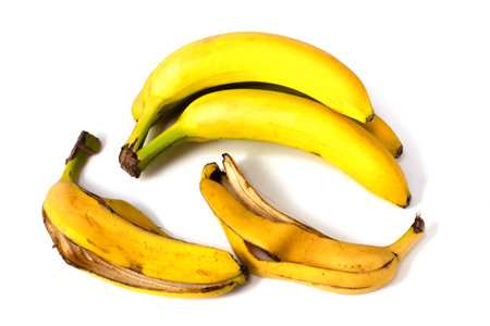 Bananas and banana peels on a white backgroundの写真素材