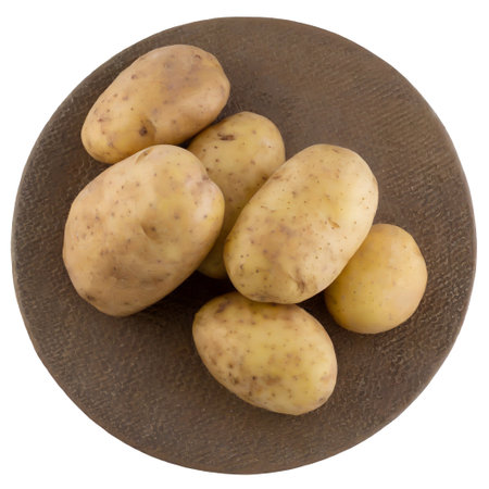 Potatoes on round stand top view isolated on white backgroundの素材