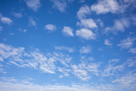 White clouds in a bright blue sky.の写真素材