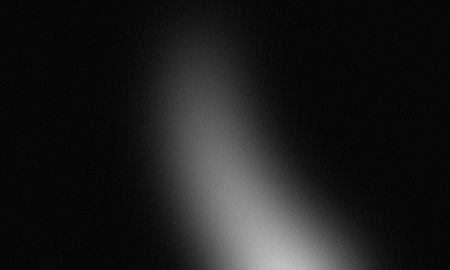 White light gradient on black background with grainy textureの写真素材